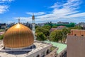 Grand Friday Mosque surrounded by buildings and trees under the sunlight in Male, Maldives Royalty Free Stock Photo