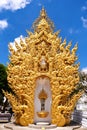 Majestic Golden Temple with White Exterior and Blue Sky in Chiang Rai, Thailand