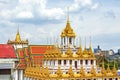 The Loha Prasart, Grand Golden Metal Pagoda wiht GOlden Mountain Background at Wat Ratchanadda Temple, Bangkok, Thailand