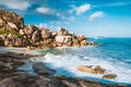 Grand L Anse, La Digue, Seychelles. Tropical coastline with hidden beach, unique granite rocks and lonely sail boat in ocean