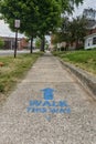 GRAND LEDGE, UNITED STATES - Jun 21, 2020: Painted sidewalk directions for COVID safety