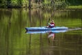 GRAND LEDGE, UNITED STATES - May 25, 2020: A women kayaker using an inflatable kayak on the Grand Rive