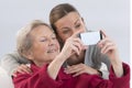 Grand-Mother and attractive young grand-daughter photographing Royalty Free Stock Photo