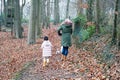 Grand mother and grandchild little girl walking together with the dogs in the countryside suburb area