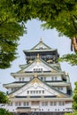 Grand Osaka Castle framed with lush vegetation Royalty Free Stock Photo