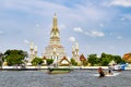 Grand Pagoda of Wat Arun Temple of Dawn with Tourist Sightseeing Boat in CHao Phraya River, Bangkok