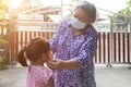 Grand parent taking face mask to kids for protect corona virus pandemic