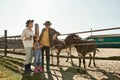 Grand parents and grand daughter near donkeys Royalty Free Stock Photo