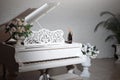 Grand piano in a luxury white classic interior with wine, palms and flowers. Royalty Free Stock Photo