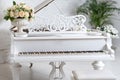 Grand piano in a luxury white classic interior with wine, palms and flowers. Royalty Free Stock Photo