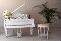 Grand piano in a luxury white classic interior with wine, palms and flowers. Royalty Free Stock Photo