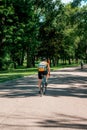 Grand Rapids, MI, USA - June 22nd 2019: Bicyclist riding down a park path