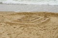 Grand sand castle on an empty beach