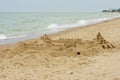 Grand sand castle on an empty beach