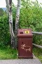 GRAND TETON NATIONAL PARK, WY, USA Ã¢â¬â JULY 19, 2021: Bear proof garbage can next to a quaking aspen tree