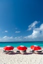 Grand Turk, Turks and Caicos - December 29, 2015: summer seaside beach with sunbed and red umbrella