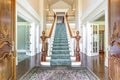 Grand two story foyer with elegant staircase. Royalty Free Stock Photo