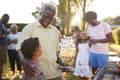 Grandad and dad talking with kids at a family barbecue Royalty Free Stock Photo