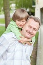 The grandad play with grandson in city park