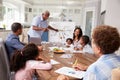 Grandad presenting at a multi generation family home meeting Royalty Free Stock Photo