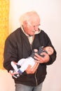 Grandfather holding newborn baby boy