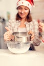 Grandchild on christmas day sifting flour for cookies