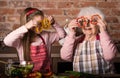 Grandchild with granny holding slices of pepper