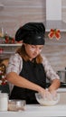 Grandchild wearing apron preparing homemade winter biscuits dough in culinary kitchen