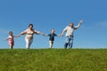 Grandchildren and grandparents running on hill Royalty Free Stock Photo