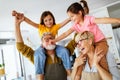 Grandchildren having fun at home while playing with their grandparents Royalty Free Stock Photo