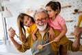 Grandchildren having fun at home while playing with their grandparents Royalty Free Stock Photo