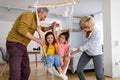 Grandchildren having fun at home while playing with their grandparents Royalty Free Stock Photo