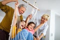 Grandchildren having fun at home while playing with their grandparents Royalty Free Stock Photo