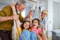 Grandchildren having fun at home while playing with their grandparents Royalty Free Stock Photo