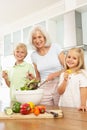 Grandchildren Helping Grandmother To Prepare Salad Royalty Free Stock Photo