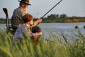granddad with grandson fishing together, teaching little young boy to be fisherman Royalty Free Stock Photo