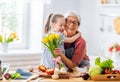 Granddaughter is giving flowers to her grandmother Royalty Free Stock Photo