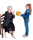 Granddaughter giving gift to her grandmother Royalty Free Stock Photo