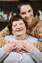 Granddaughter giving a hug to her grandma Royalty Free Stock Photo