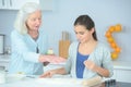 granddaughter with grandma cooking together