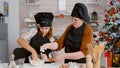 Granddaughter with grandma preparing traditional homemade dough baking traditional cookies dessert Royalty Free Stock Photo