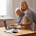 Granddaughter, grandmother and help with laptop for budget, finance and technology with advice and assistance. Women pay Royalty Free Stock Photo