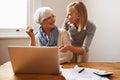 Granddaughter, grandmother and helping with laptop for online payment, finance and technology with advice on budget Royalty Free Stock Photo