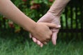 Granddaughter and grandmother holding hands outdoors close up Royalty Free Stock Photo