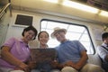 Granddaughter with grandparents sitting in the subway and looking at the map Royalty Free Stock Photo