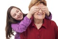 Granddaughter hands over grandmother eyes close up