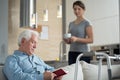 Granddaughter helping her disabled grandpa Royalty Free Stock Photo