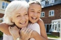 Granddaughter Hugging Grandmother On Bench During Visit To Retirement Home Royalty Free Stock Photo