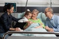 Granddaughter hugging sick elderly grandmother visiting her in hospital ward Royalty Free Stock Photo