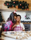 Granddaughter kisses her grandmother in the kitchen Royalty Free Stock Photo